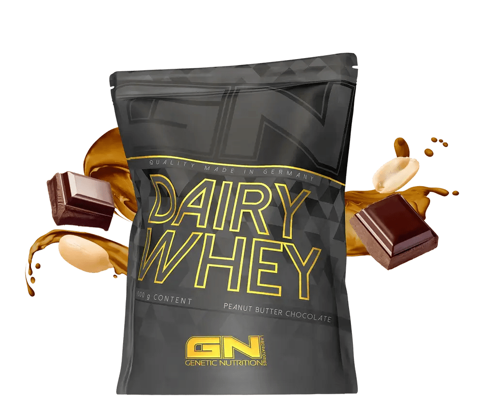 GN Dairy Whey isrugu baltymai peanut butter chocolate flavor packaging with chocolate and nuts backdrop.