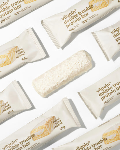 Double Trouble Bar Coconut & Almond – baltyminis batonėlis su kokosu ir migdolais (55 g) - Realsport.lt