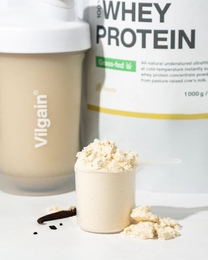 Grass-Fed Whey Protein powder in scoop with Vilgain shaker, highlighting premium quality protein blend.